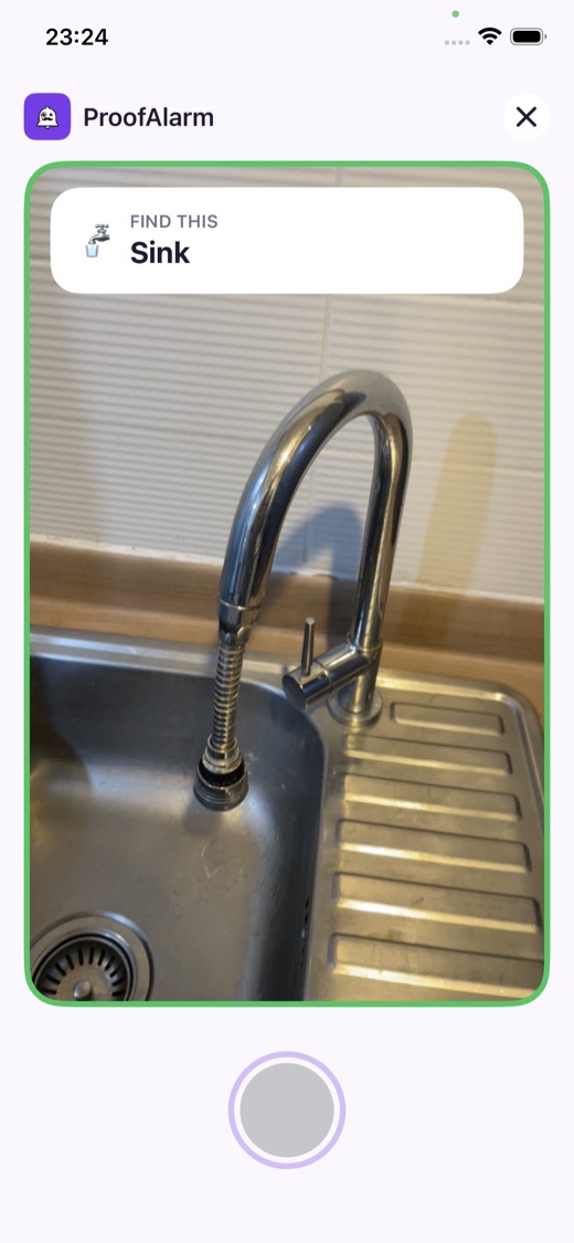 The ProofAlarm object hunt screen: a card reading Find this: Sink, above a photo of a kitchen sink inside a green verified border.